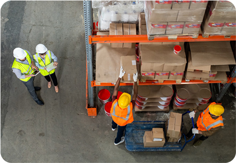 Four men loading and unloading goods from a top-angle view.